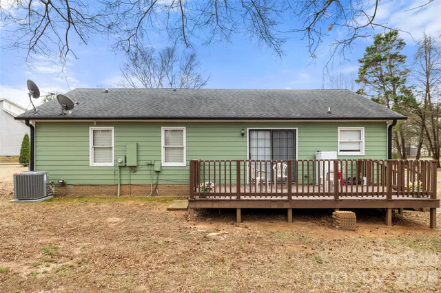 a backyard of a house with barbeque oven and a table