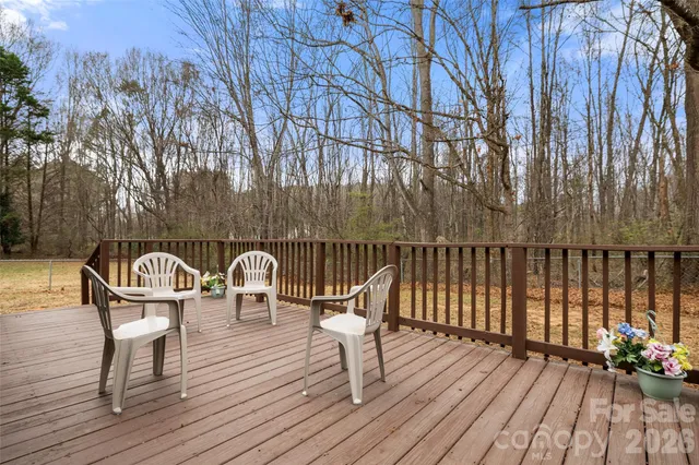 a table and chairs on wooden deck