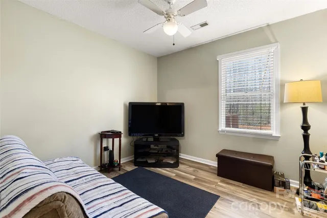 a bedroom with a bed and a television