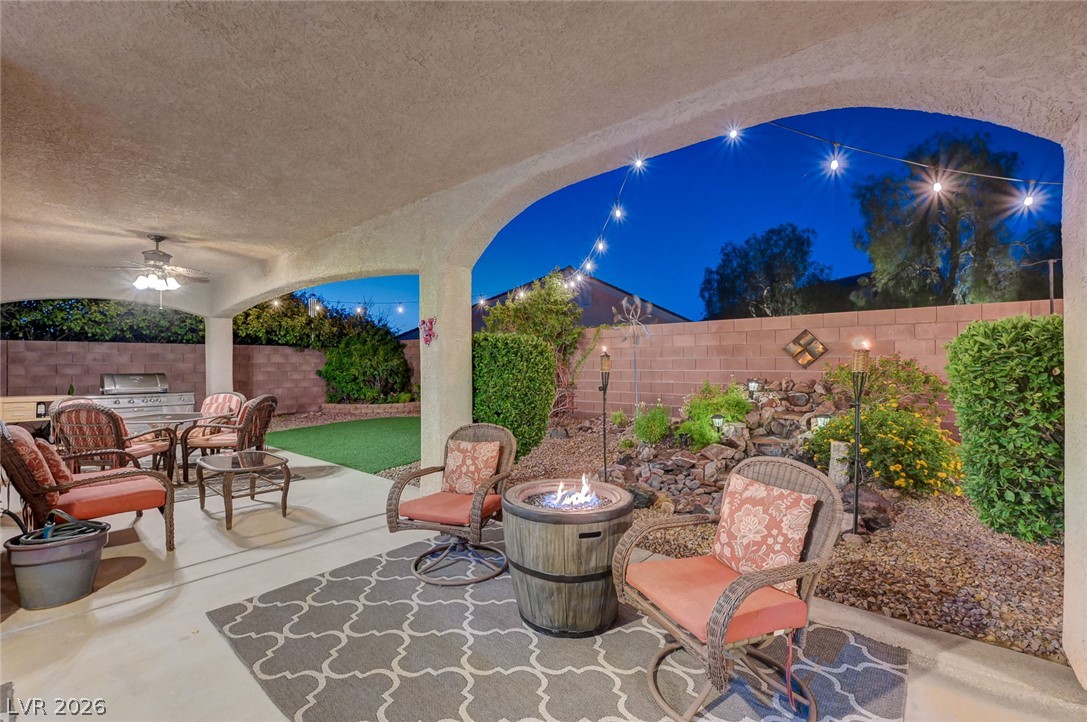1604 Cattle Ranch Place Henderson, NV 89002 - Photo 89 of 99 An inviting covered patio featuring a built-in barbecue and a cozy fire pit.