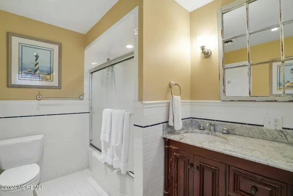 a bathroom with a sink a toilet and mirror