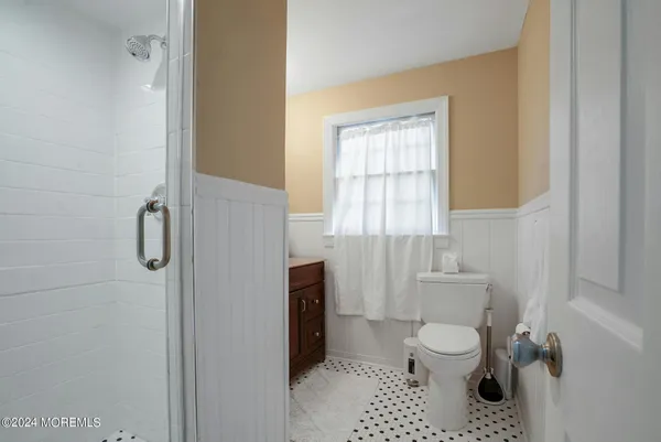 a bathroom with a granite countertop sink a toilet and a mirror