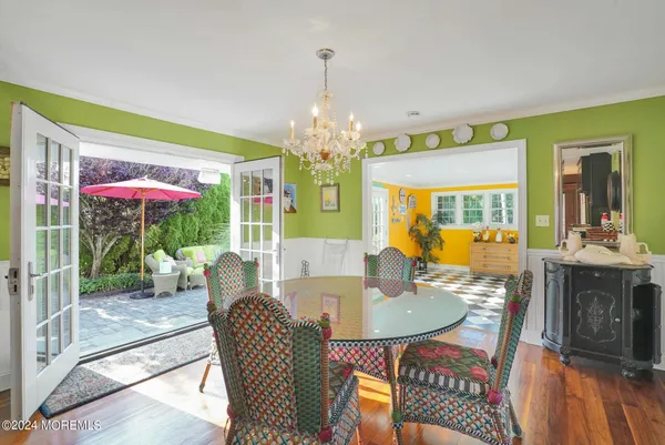a kitchen with stainless steel appliances granite countertop a stove top oven a sink dishwasher and wooden cabinets with wooden floor