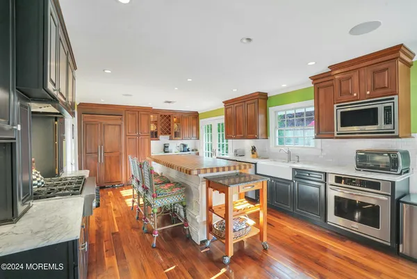 a large kitchen with stainless steel appliances and a large window