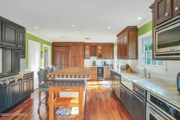 a view of kitchen with windows cabinet and front door