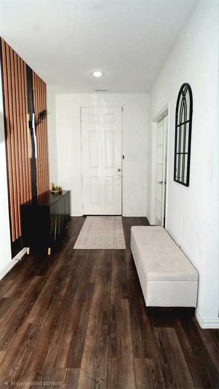 502 Virginia Way Princeton, TX 75407 - Photo 2 of 9 Entryway featuring wood-finish flooring, a paneled front door, and a decorative slatted wall accent