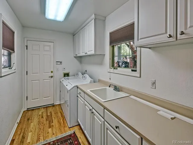a utility room with cabinets washer and dryer