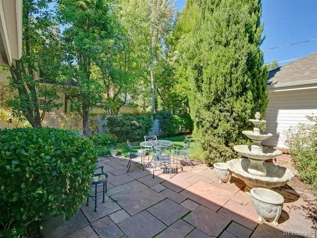 a backyard of a house with outdoor seating