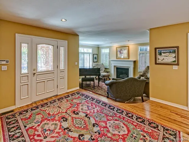 a living room with furniture rug and wooden floor