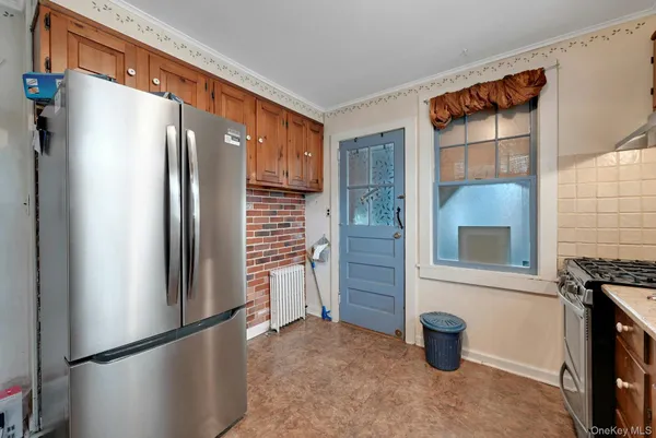 a kitchen with stainless steel appliances a refrigerator and a stove top oven