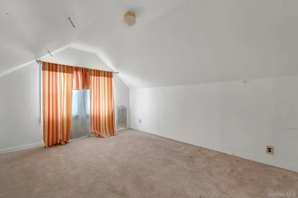 an empty room with windows and a ceiling fan