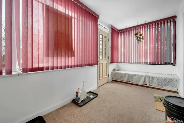 a view of a room with a window and a chair