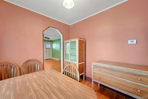 a view of a bedroom with wooden floor