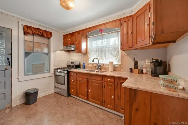 a kitchen with stainless steel appliances granite countertop a sink stove and cabinets