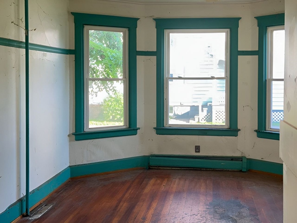 11-15 Perry Street North Adams, MA 01247 - Photo 18 of 22 a view of an empty room with wooden floor and a window