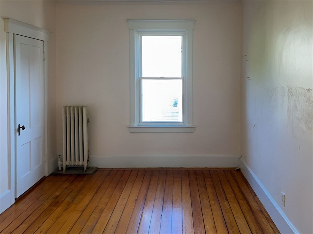11-15 Perry Street North Adams, MA 01247 - Photo 21 of 22 an empty room with wooden floor and windows