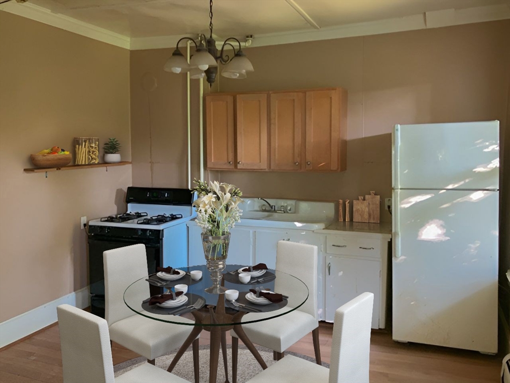 11-15 Perry Street North Adams, MA 01247 - Photo 8 of 22 a kitchen with a table and chairs in it