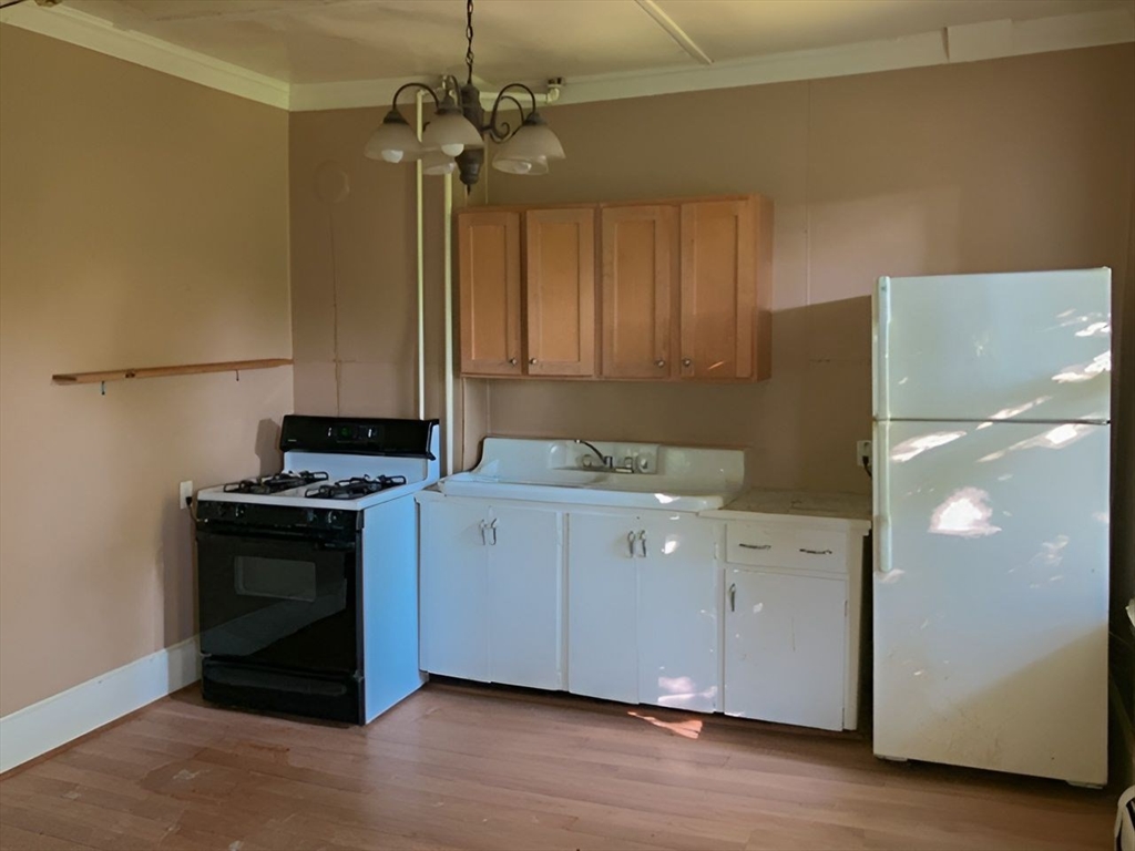 11-15 Perry Street North Adams, MA 01247 - Photo 9 of 22 a kitchen with a stove and a refrigerator