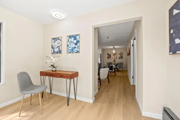a view of a room with furniture and wooden floor
