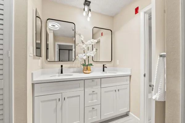 a bathroom with a double vanity sink mirror and