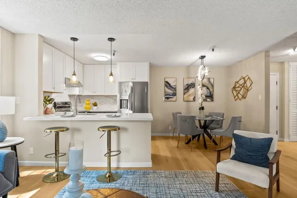 a living room with kitchen island furniture and a chandelier