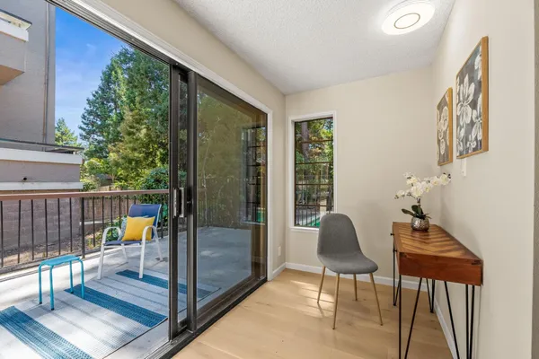 a living room with furniture and a floor to ceiling window