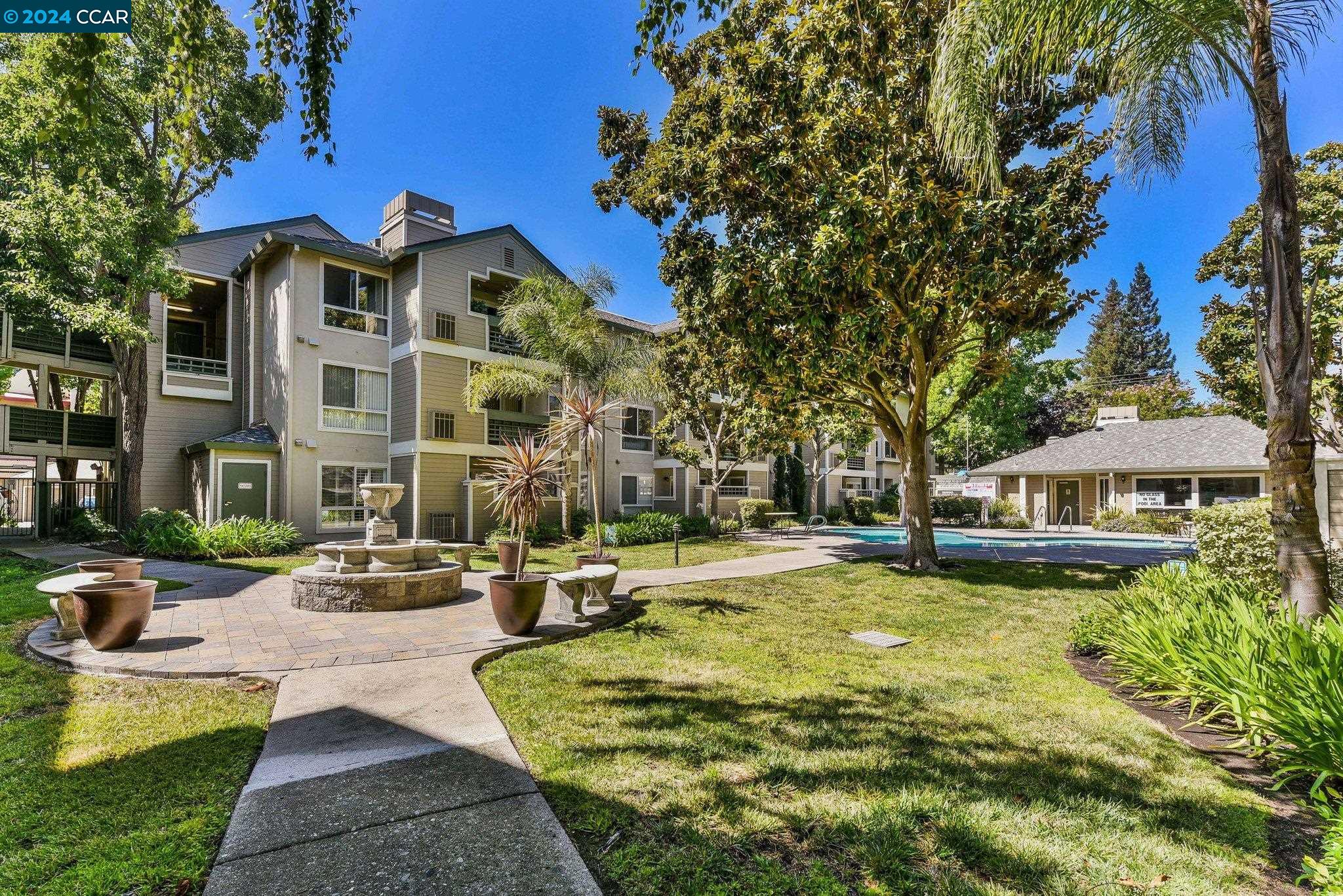 2530 Oak Road, Unit 202 Walnut Creek, CA 94597 - Photo 1 of 1 a view of a building with garden and trees