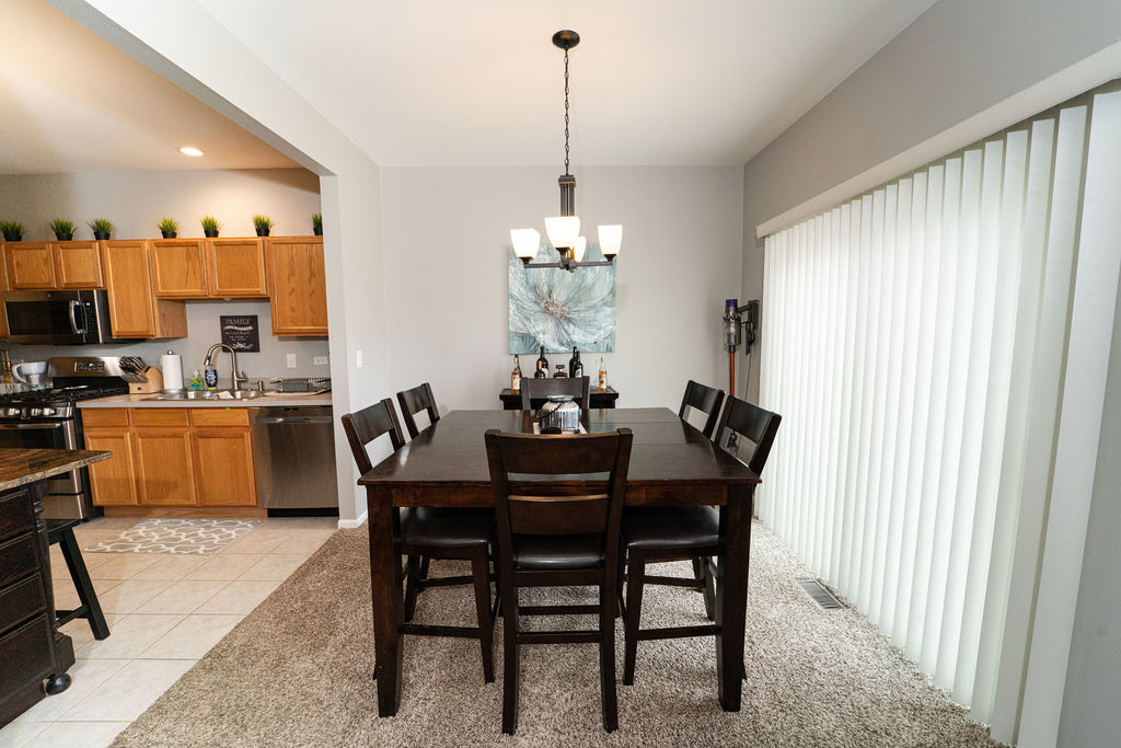364 Littleton Trail Elgin, IL 60120 - Photo 14 of 36 a dining room with furniture a chandelier and window