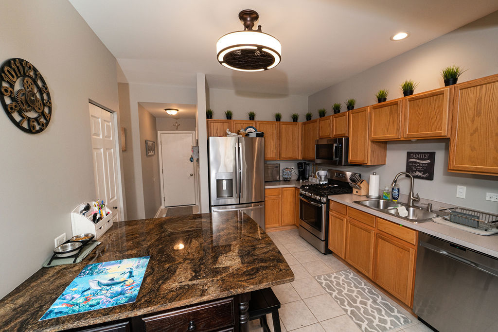 364 Littleton Trail Elgin, IL 60120 - Photo 15 of 36 a large kitchen with stainless steel appliances granite countertop a stove and a sink