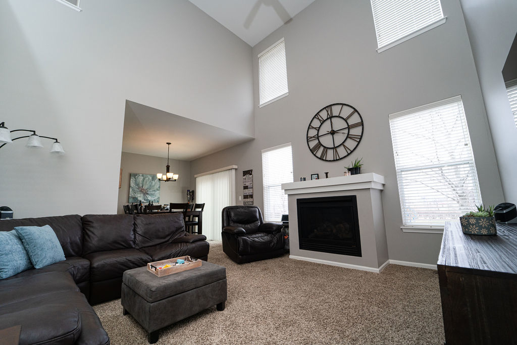 364 Littleton Trail Elgin, IL 60120 - Photo 9 of 36 a living room with furniture a fireplace and a large window