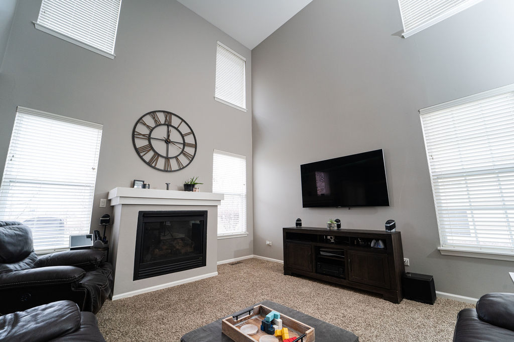 364 Littleton Trail Elgin, IL 60120 - Photo 10 of 36 a living room with furniture a flat screen tv and a fireplace
