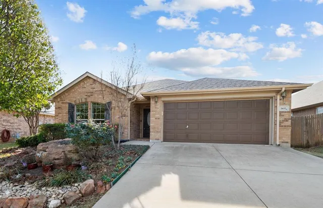a view of a house with a yard and garage