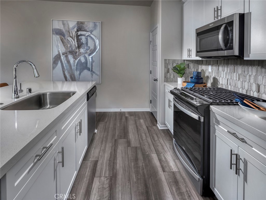 2147 Bergamot Street Redlands, CA 92374 - Photo 4 of 20 a kitchen with a sink stove and microwave