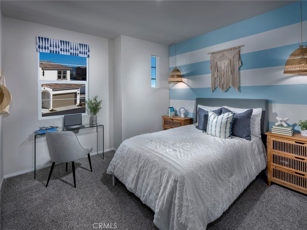 2147 Bergamot Street Redlands, CA 92374 - Photo 9 of 20 a bedroom with a bed a chair and potted plant on the dresser