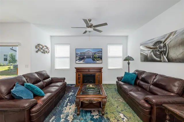 a living room with furniture a rug and a chandelier