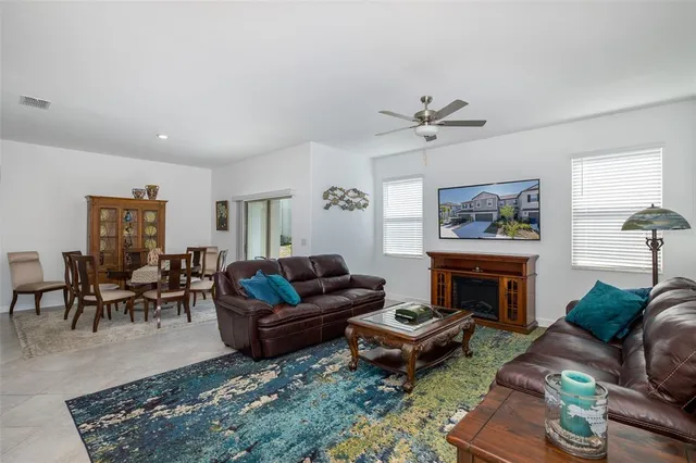 a kitchen with stainless steel appliances a stove a sink a refrigerator and white cabinets with wooden floor