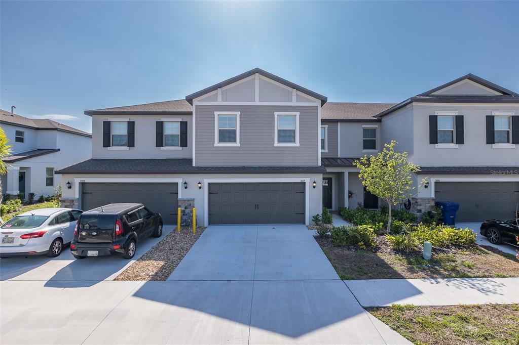 3072 Hover Hall Lane New Port Richey, FL 34655 - Photo 2 of 51 a front view of a house with a garden