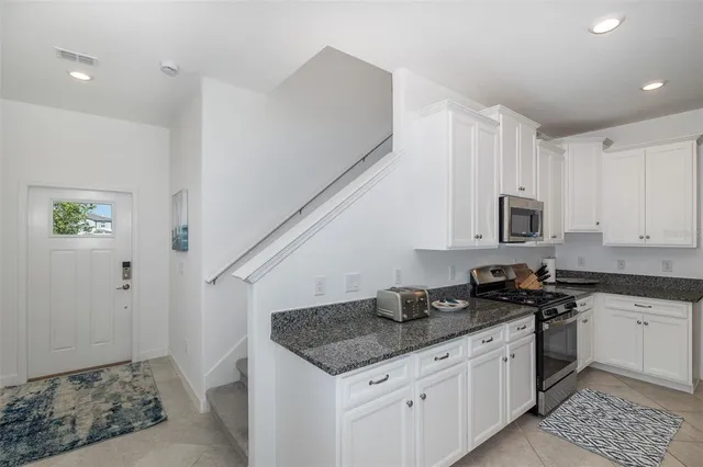 a white toilet sitting next to a white walls