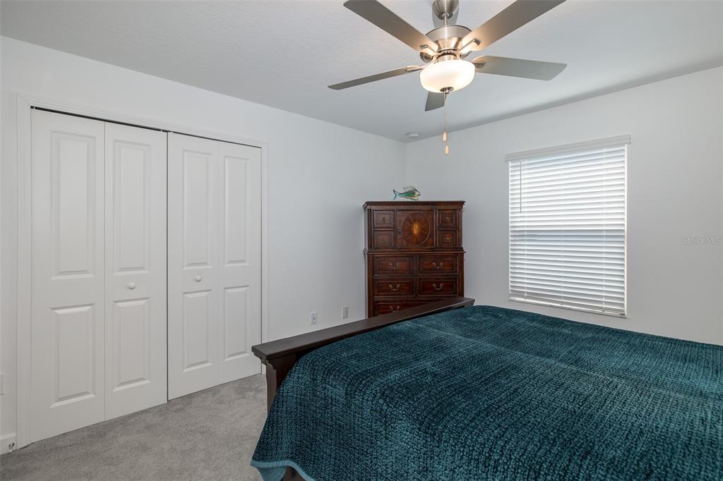 3072 Hover Hall Lane New Port Richey, FL 34655 - Photo 38 of 51 a bedroom with a bed and a ceiling fan