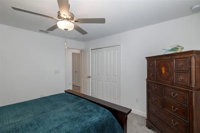 a bathroom with a granite countertop sink a toilet and a mirror