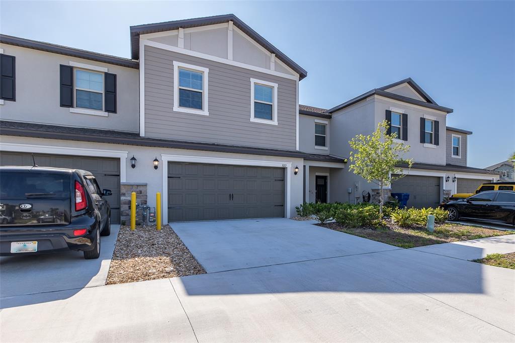 3072 Hover Hall Lane New Port Richey, FL 34655 - Photo 4 of 51 a front view of a house with a yard and garage