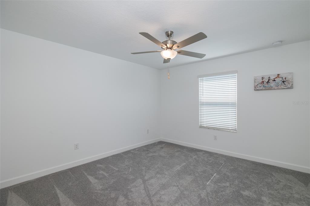 3072 Hover Hall Lane New Port Richey, FL 34655 - Photo 44 of 51 an empty room with a window and a fan