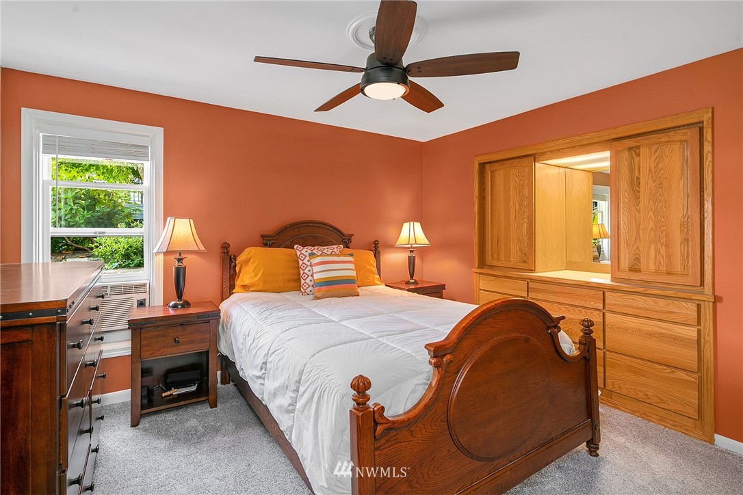 830 Main Street Edmonds, WA 98020 - Photo 12 of 29 a bedroom with a bed and a chandelier