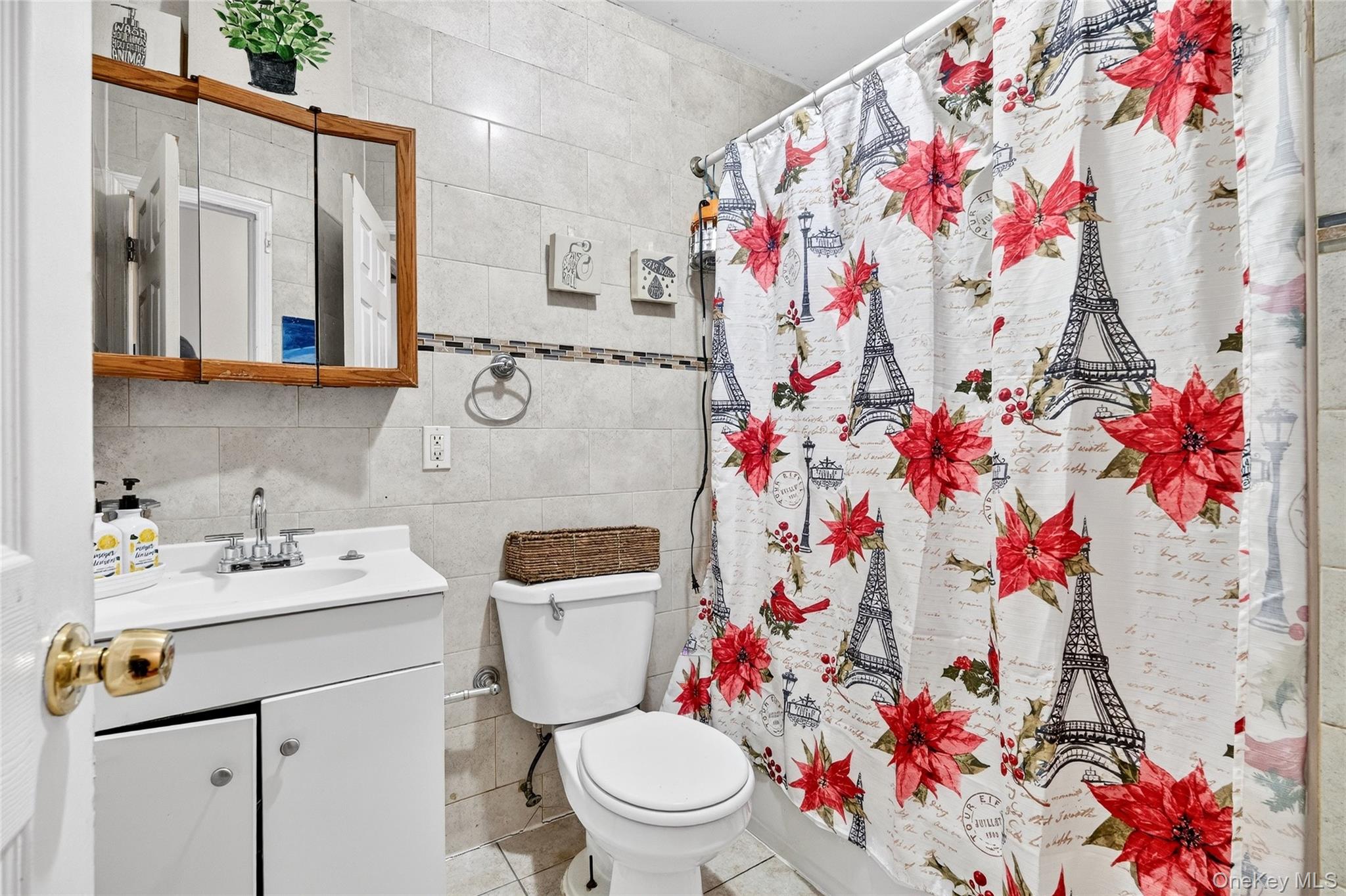 1459 Rosedale Avenue Bronx, NY 10460 - Photo 21 of 37 Bathroom with vanity, tile walls, light tile patterned flooring, and shower / bath combination with curtain