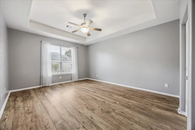 wooden floor in an empty room with a window