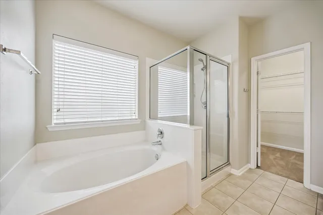 a bathroom with a bathtub and a shower