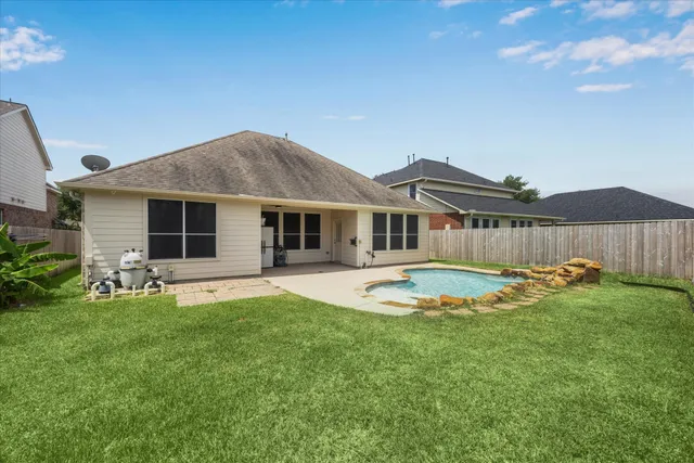 a view of a house with backyard and sitting area