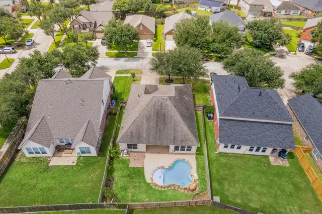 an aerial view of multiple houses with yard