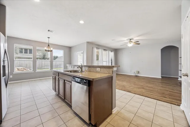 a kitchen with stainless steel appliances granite countertop a stove and a sink