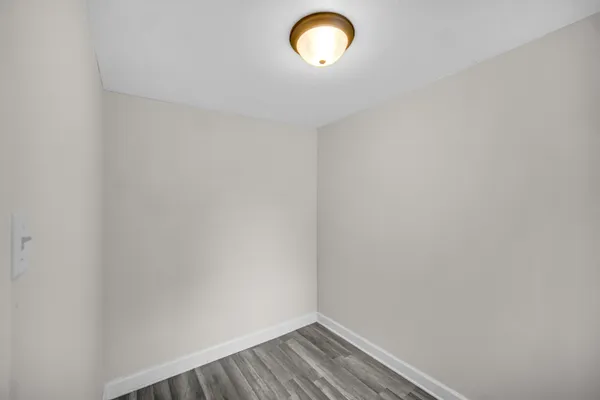 a view of walk in closet with empty racks